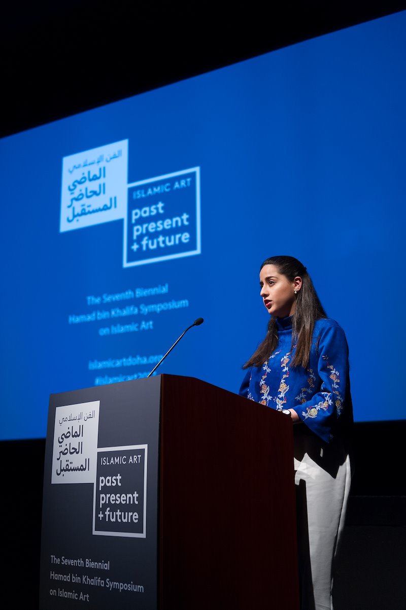 VCUarts Qatar student Noor Hamade introduces speaker Venetia Porter at the art symposium. Photo by Kevin Morley, VCU University Relations.