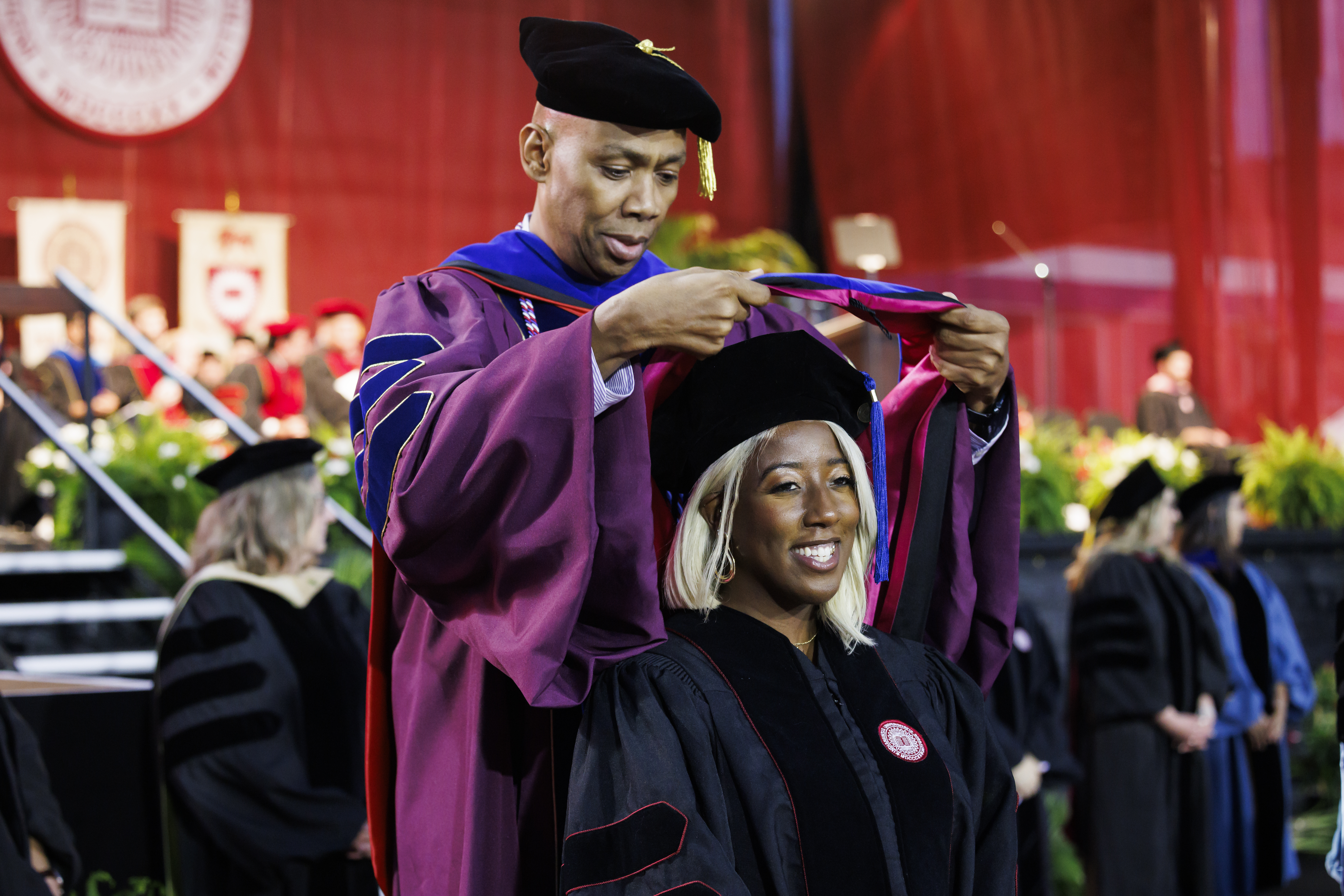 A graduate receives her doctoral hood during the IU Indianapolis ...