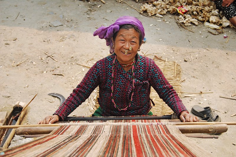 A kulung woman weaves a sacred cloth from stinging nettle fibers