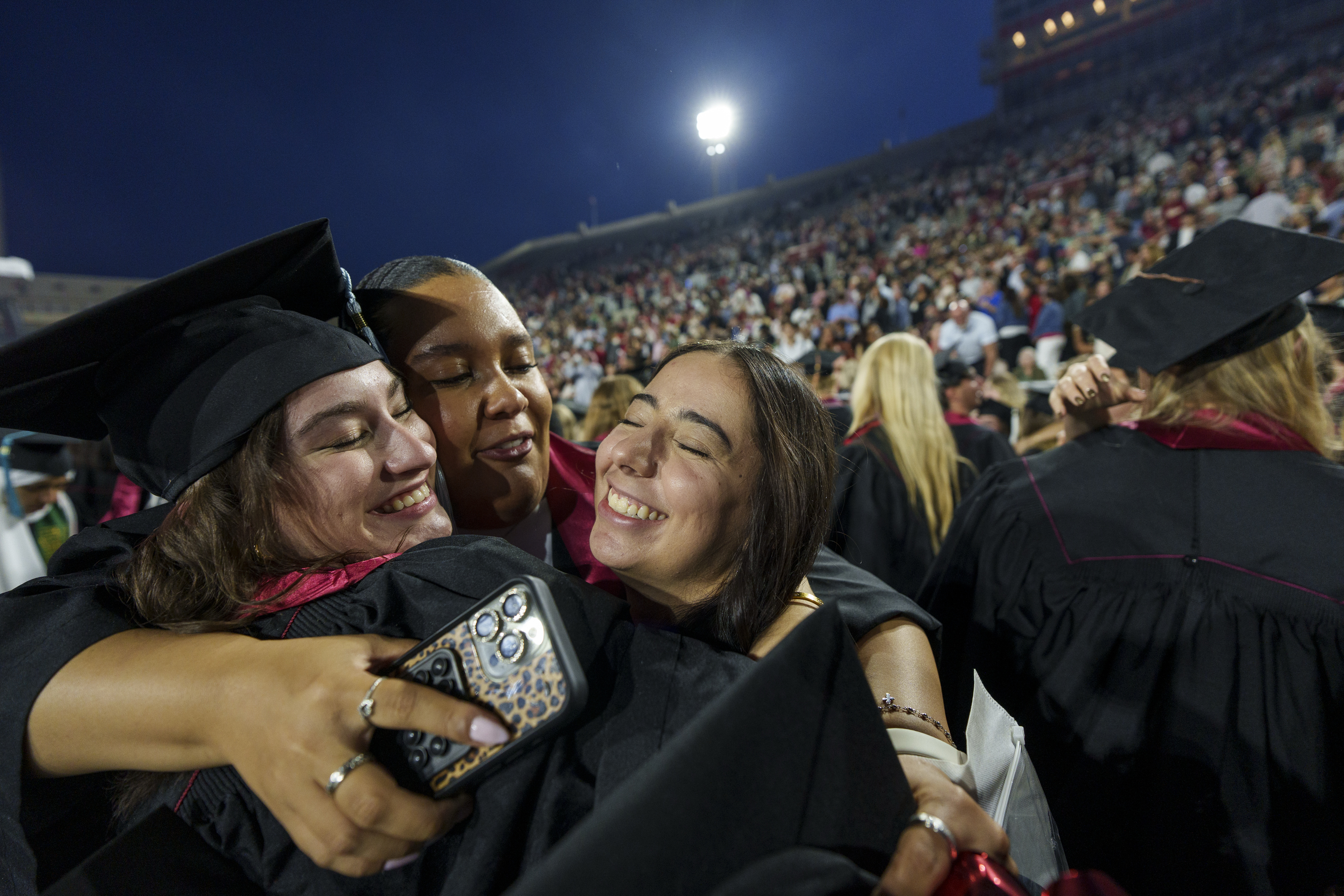 Graduates share a hug following the IU Bloomington Undergraduate ...