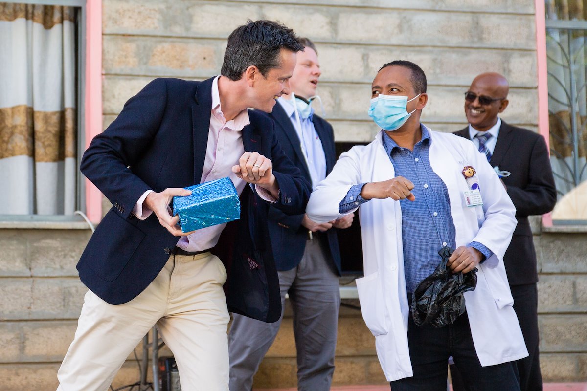 Dr. Rick elbow bumps Dr. Mesfin after an appreciation speech.