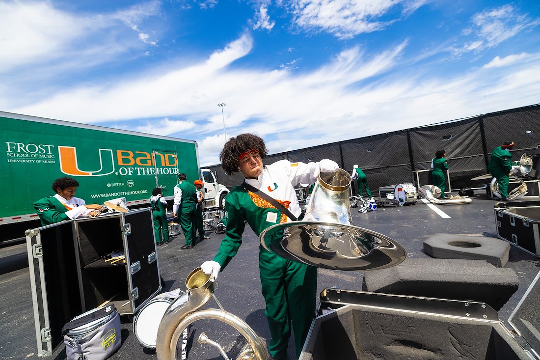 Mario Sanchez, a sophomore tuba player re assemblies his tuba after arriving at Hard Rock Stadium.
