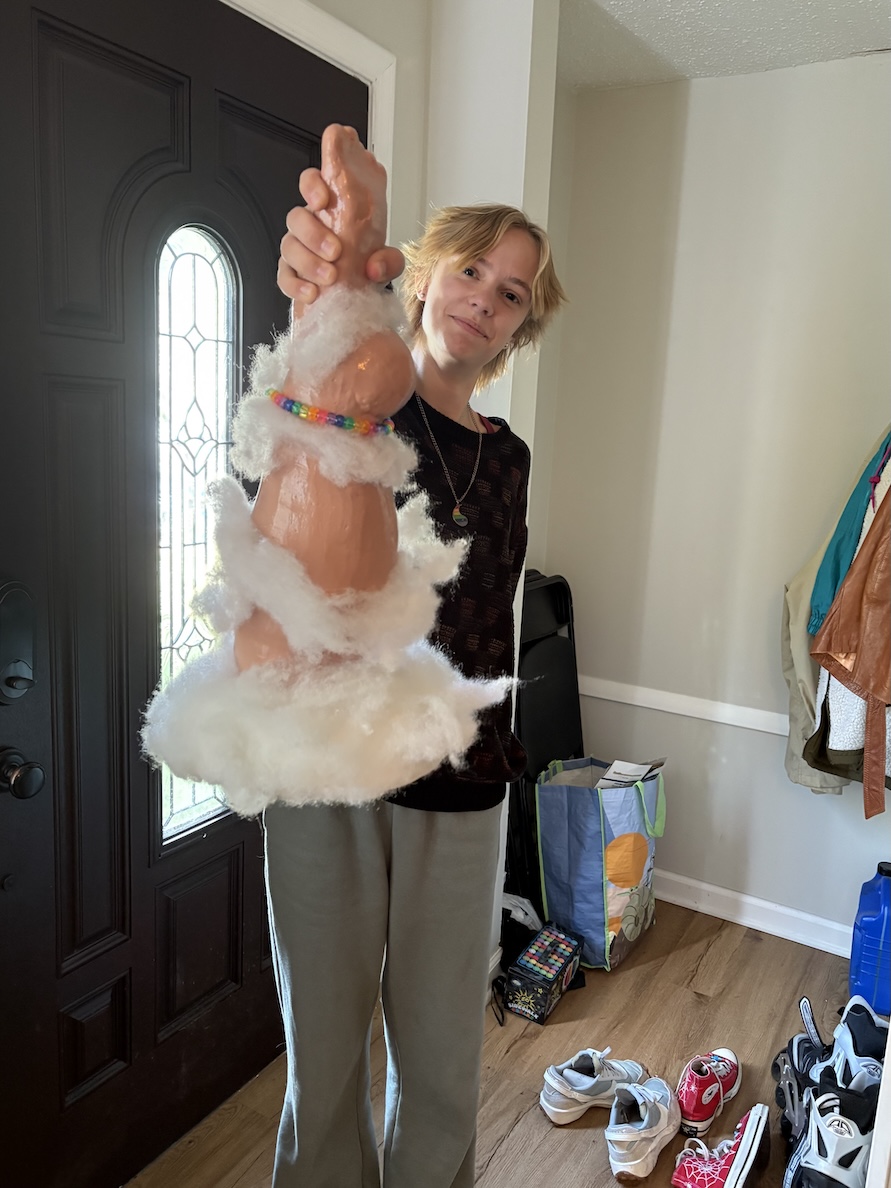 Ellena Purvis holds up a sculpture of a foot.