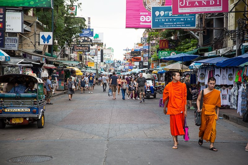 Two novice monks stroll down Bangkok's famous Khaosan Road.