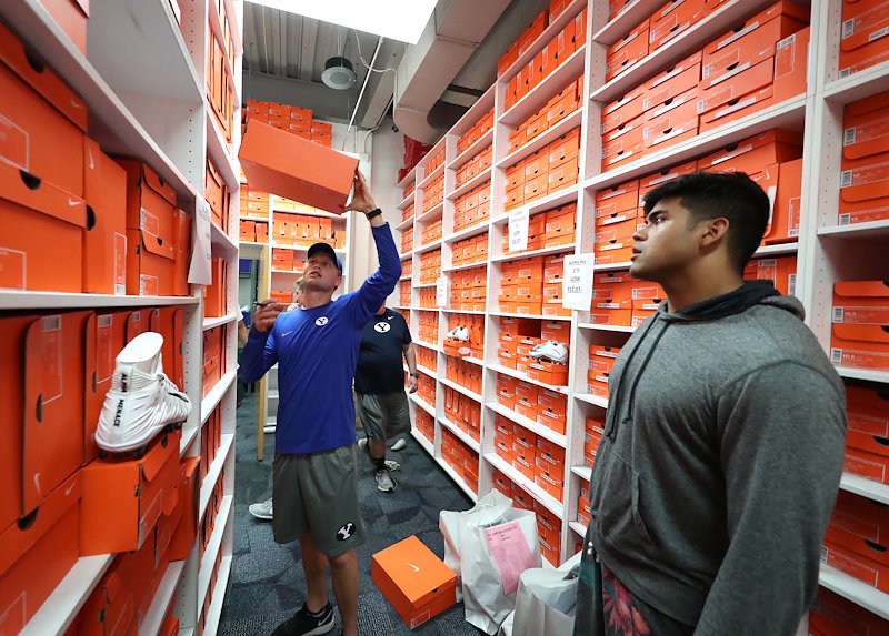 Players try on cleats in the shoe room. Photo by Jaren Wilkey/BYU