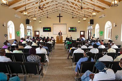 Executive Director Tim Erickson encourages co-workers to put all their trust in the Lord and reads from Matthew 6:34.