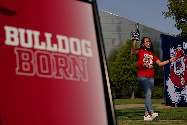 A student cheers during the New Student Convocation parade