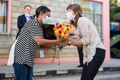 Dr. Rick's wife Anne receives flowers from Nurse Matron Sara.