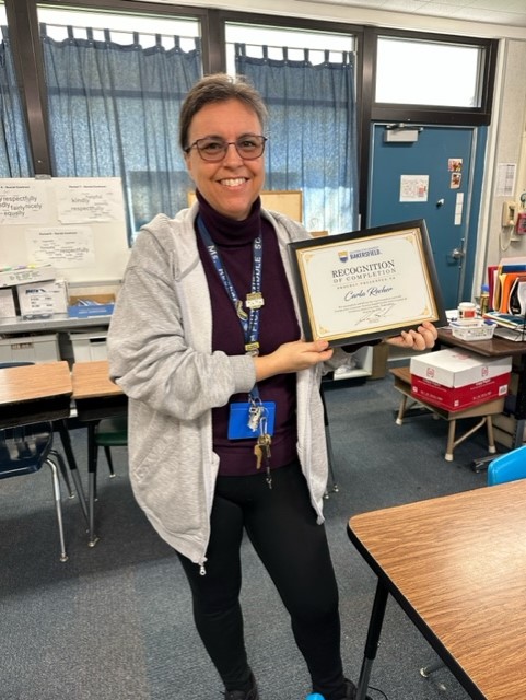 Piute Middle School TeacherCarla Recher holds up her certificate for ...