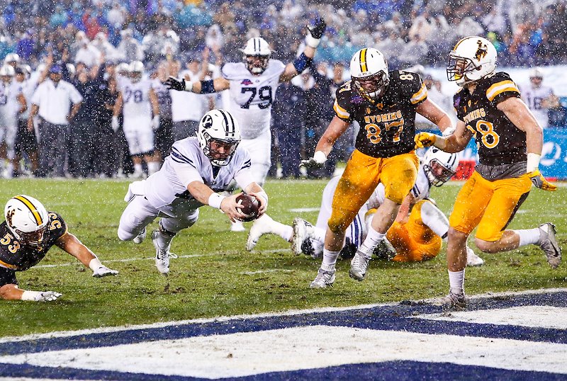 BYU quarterback Tanner Mangnum dives for a touchdown in BYU's win over Wyoming in the Poinsettia Bowl - Photo by SavannahTittle/BYU