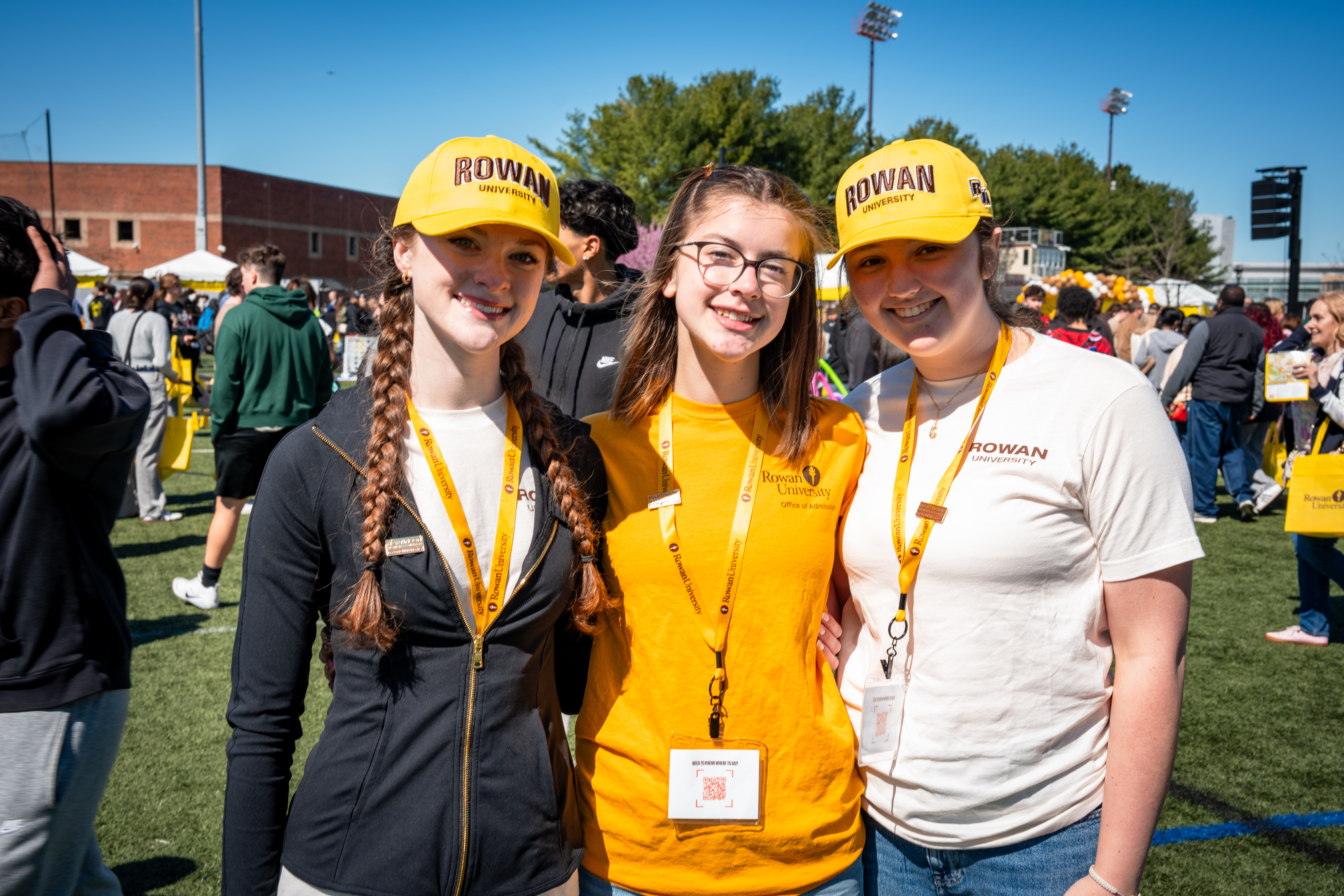 Three smiling students wearing