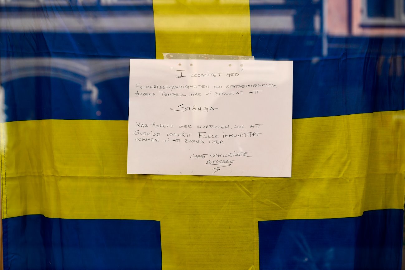 A sign in the window of the closed Schweizer Cafe reads they will be closed until herd immunity is reached, in Stockholm, Sweden, on Thursday, March 26, 2020.