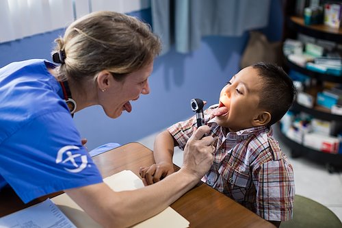 Dr. Judy Blumhoffer examines Eder’s cleft palate prior to his surgery.