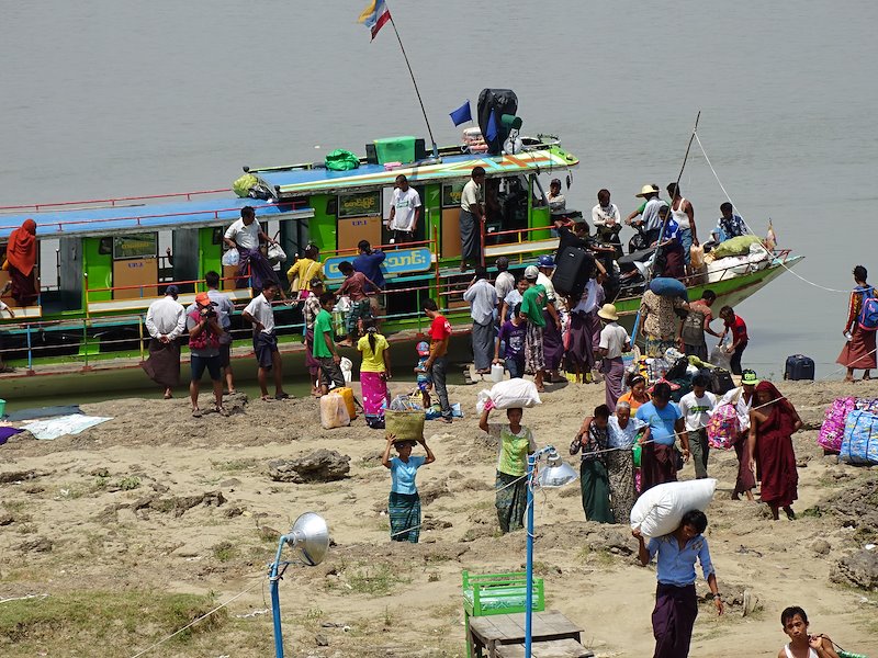 Commuters disembark at the pier in Homalin township.