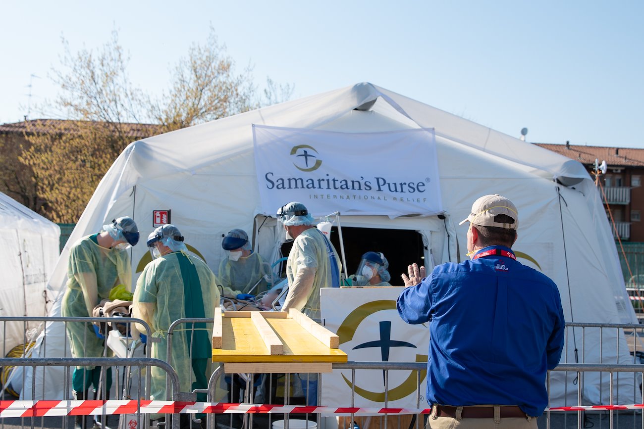 Jason, a chaplain with the Billy Graham Evangelistic Association - which works closely with Samaritan's Purse during disaster responses - watches and prays as a patient is moved to the ICU.