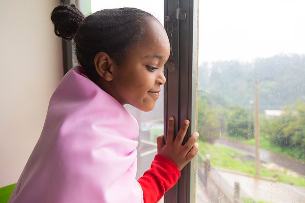 Meriyem shelters inside from the cold and wet Ethiopian rainy season