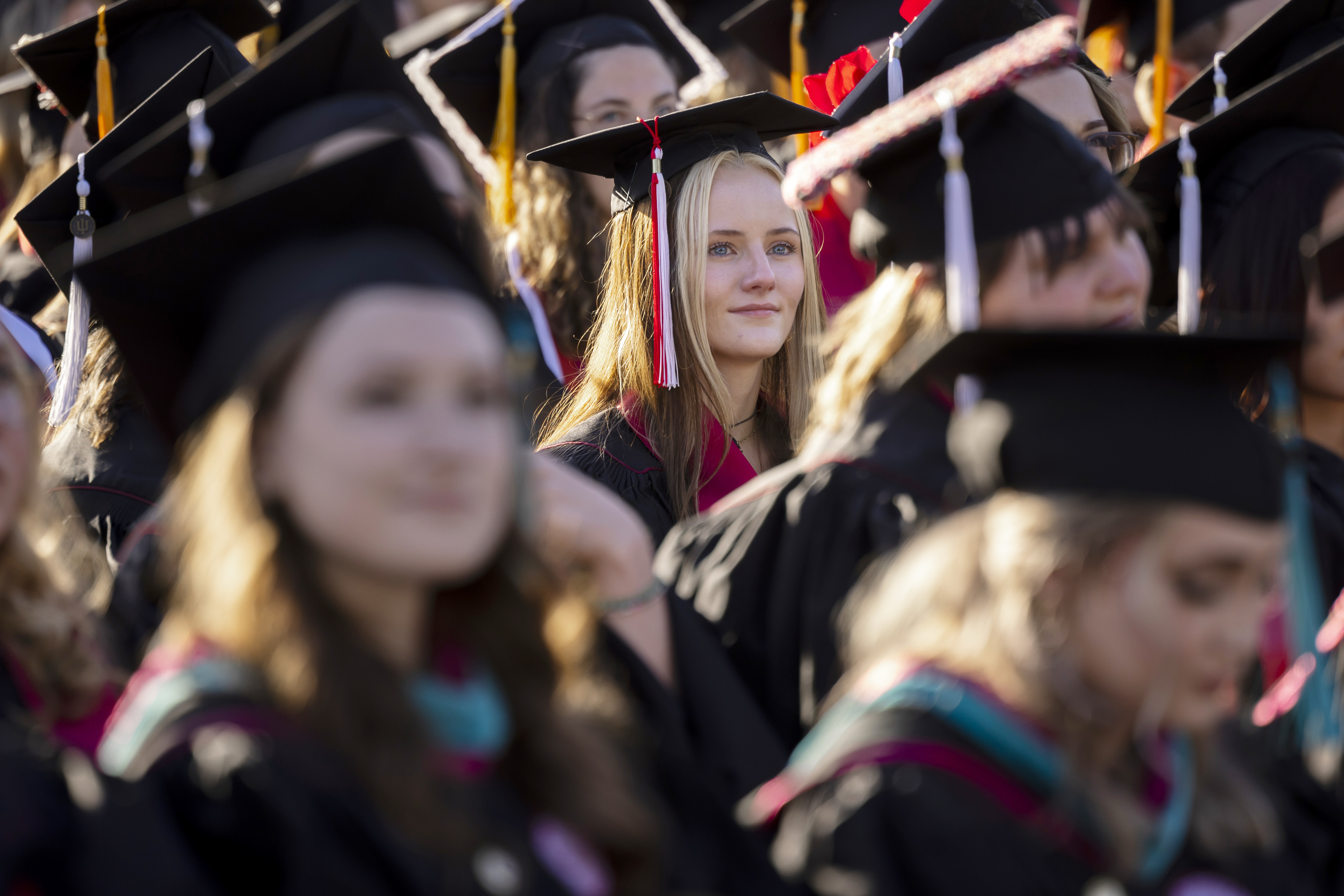 A graduate listens to a speaker during the IU Kokomo Commencement on ...
