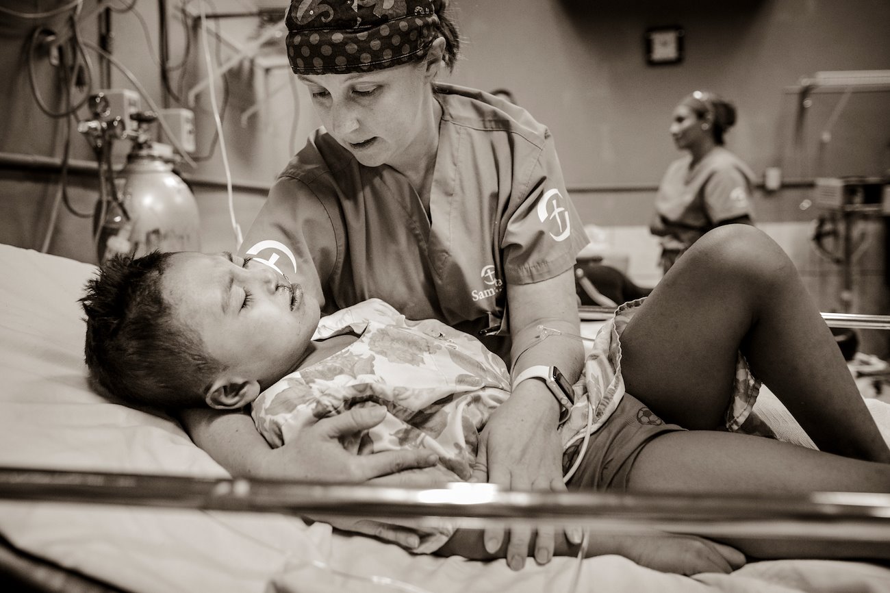 Nurse Jennifer Bender holds Eder as he recovers from surgery.