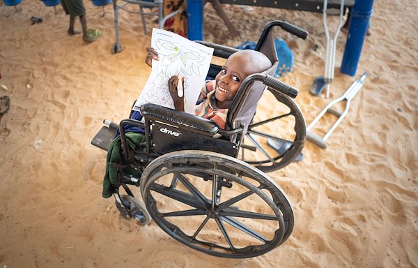 Saifullahi loves to color books! No matter the location or if he is in a wheelchair, he will do it!