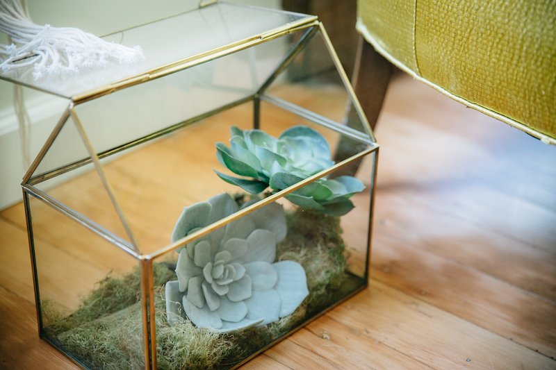 Every corner of the loft was filled with greenery. Glass terrariums like this one were a lovely motif used throughout.