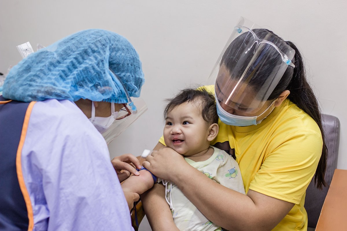 Brave Elizabeth didn't even flinch as Medical Technologist Regine got her blood sample.