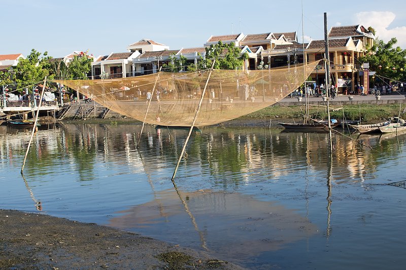 These fishing nets work via a mechanism that lowers and lifts them from the shore of the river.