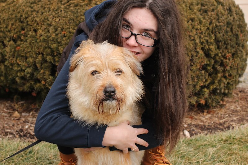17 year old Kasey McDonough loving her dog Shelby.