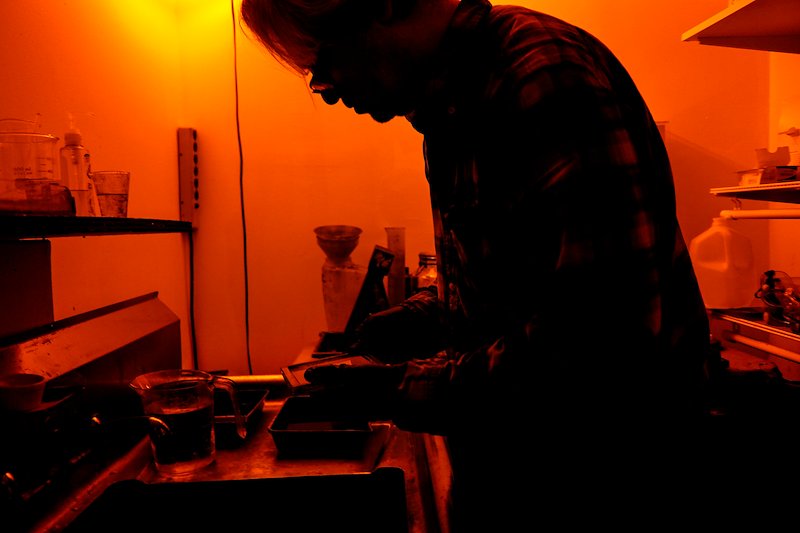 Geoffrey develops the plate in the darkroom adjacent to the studio.