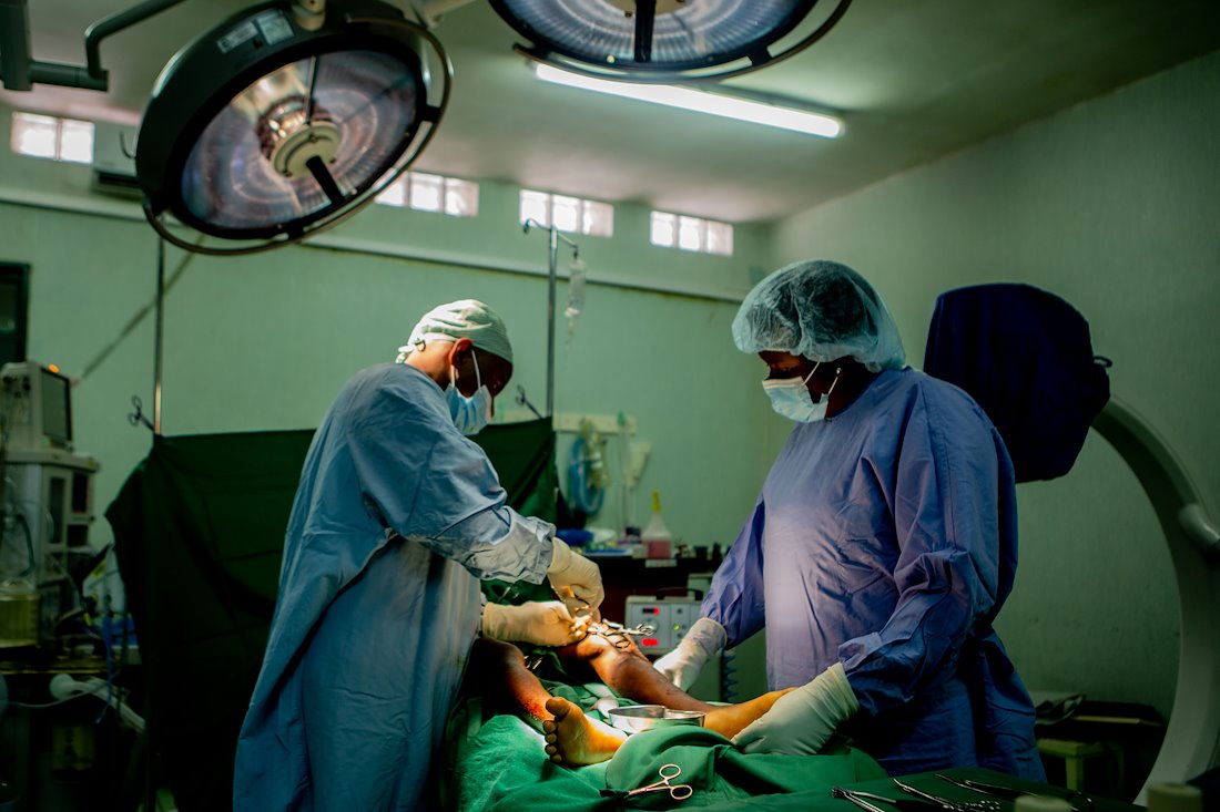 Doctors operating to correct leg issues.