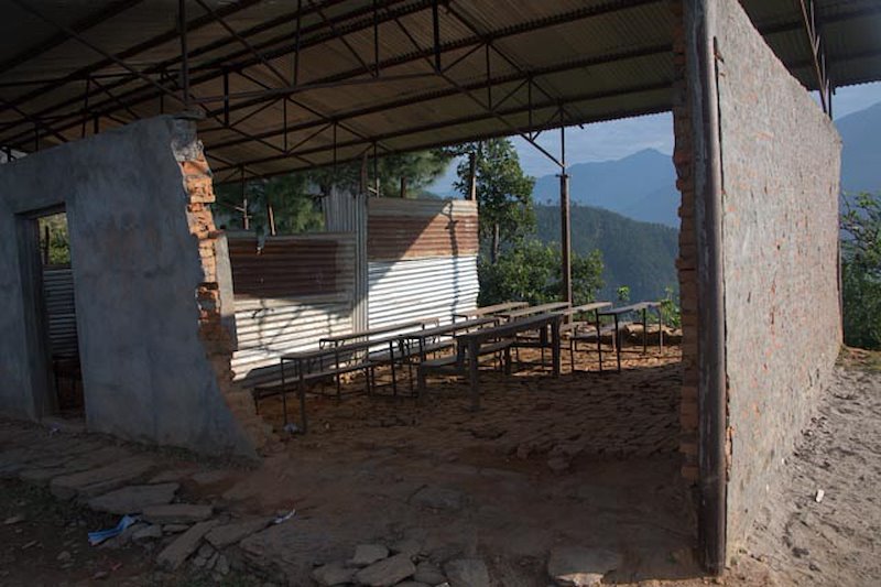 A Gorkha District school with damage from the earthquakes is still in use nineteen months later. Aid has gone to more accessible areas.