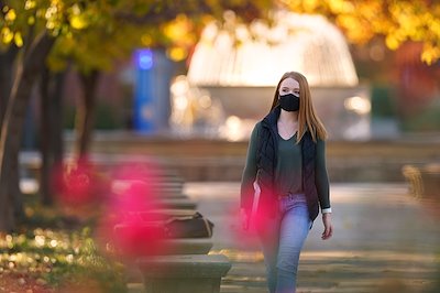 A student walks through campus in November.