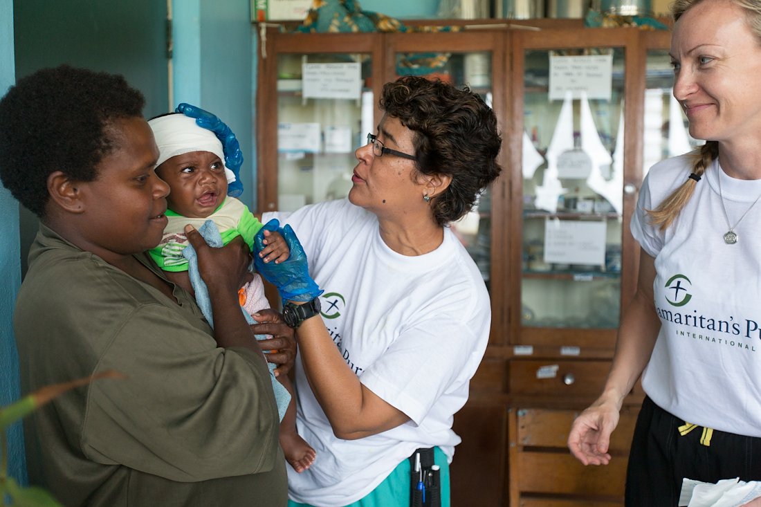 Dr. Alicia Chilito treated a baby with sores on his head while nurse practitioner Shelly Kelly comforted his mother.