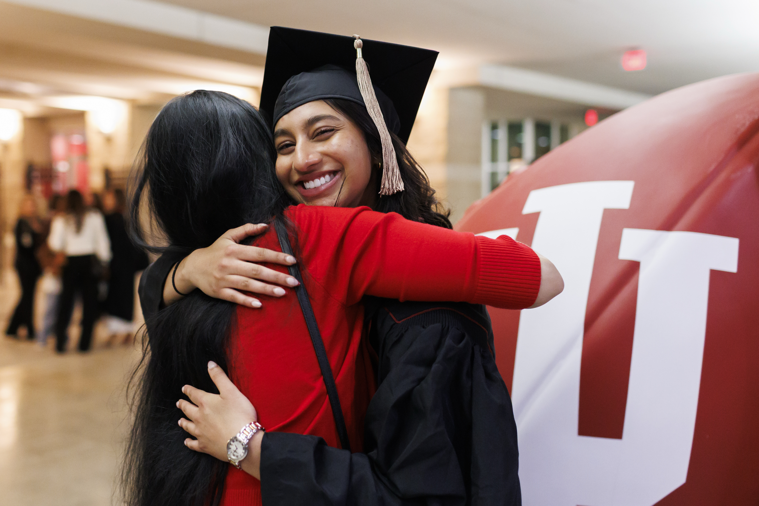 A graduate hugs a family member after the IU Bloomington Undergraduate ...