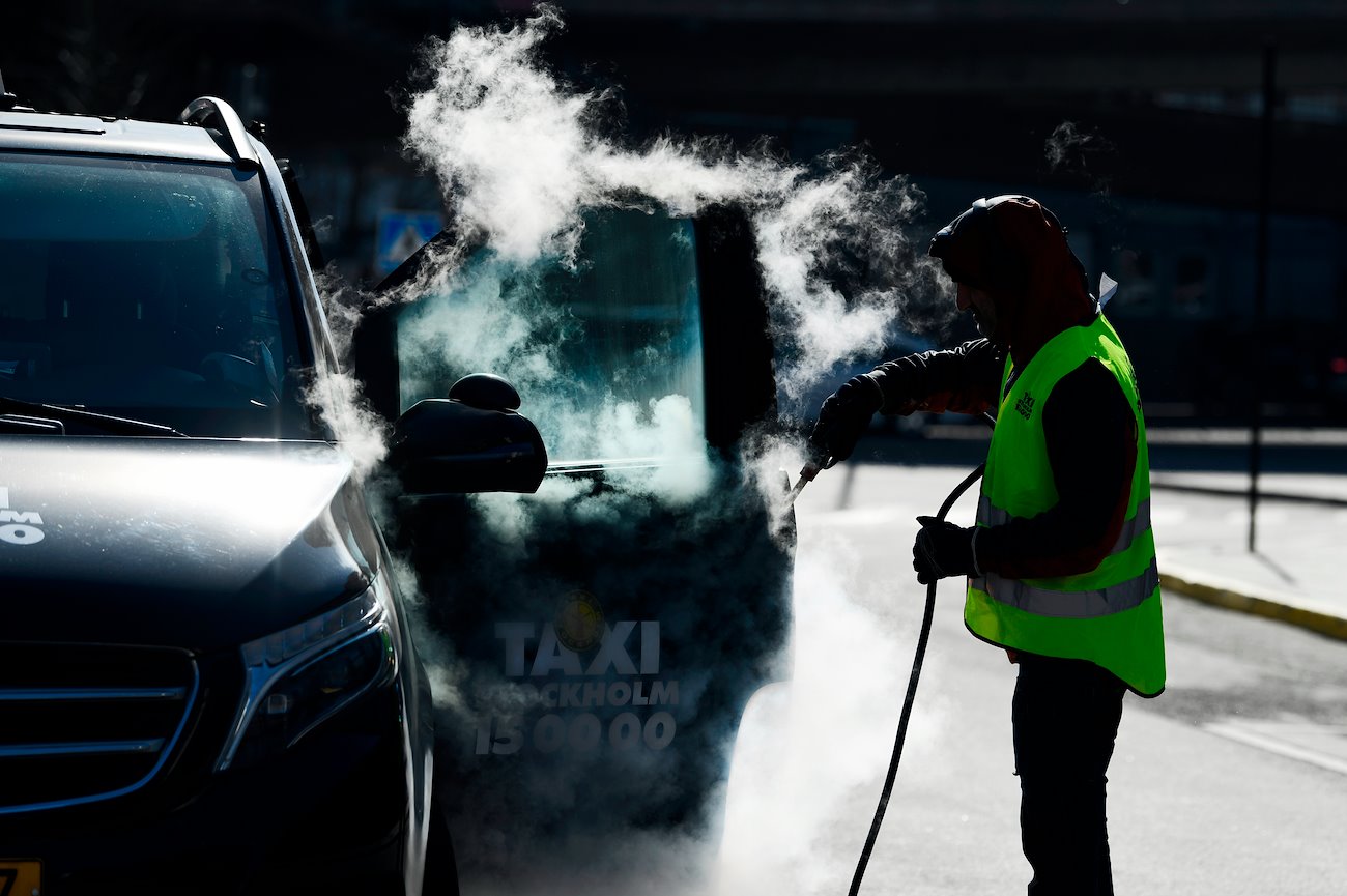 A taxi is disinfected at the city terminal in Stockholm, Sweden, on Thursday, March 26, 2020