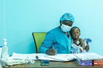 Boyd, a nurse, helps a crying child who's waiting for their mother after a successful surgery.