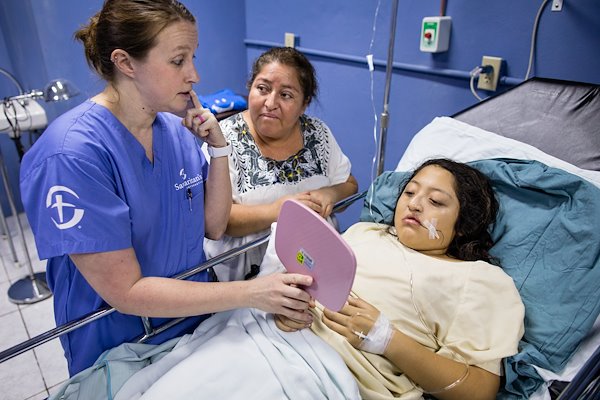 Caal sees her new smile for the first time following her surgery.