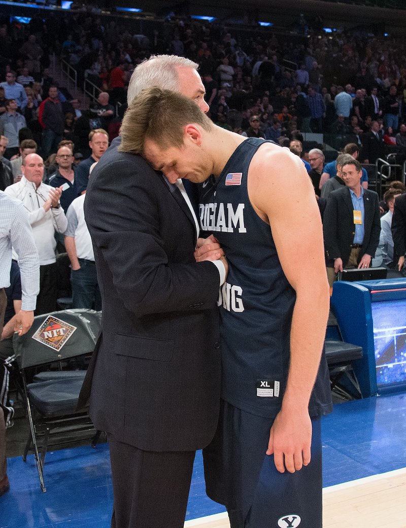 Coach Dave Rose embraces Senior Kyle Collinsworth after he completes the final game of his career for BYU - Photo by Mark A. Philbrick/BYU