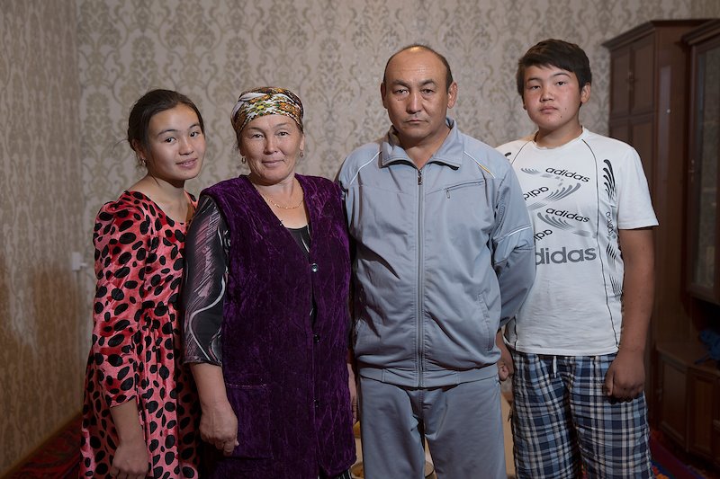 The Alimbekov family at home. Kanybek (center right) and Zhumagul are the parents of 6 children.