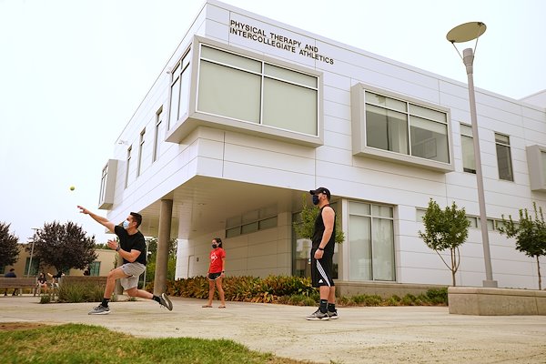 2nd year physical therapy students play a makeshift game of baseball (using a tennis ball) during a break from their Orthopedic Management Lab.