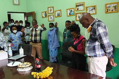 Carol and Moses being prayed for by their colleagues on their birthday. "These are the little things that stick on our memories," Moses said