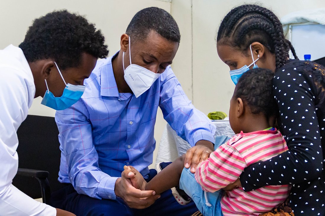 CURE Ethiopia Orthopedic Surgeon Dr. Tewodros examining a patient and teaching a resident at the same time during the Hawassa Mobile Clinic.