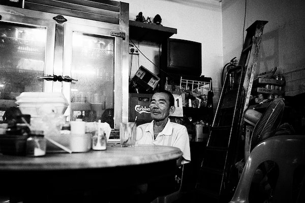 he is always in the same corner with his black coffee and a cigarette.