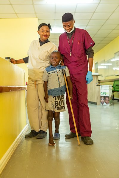 Robert takes a picture with the nurses while playing.