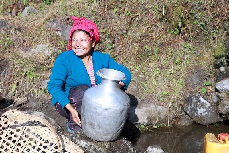 Collecting water with a smile. Our drinking water projects can save women more than two hours each day.