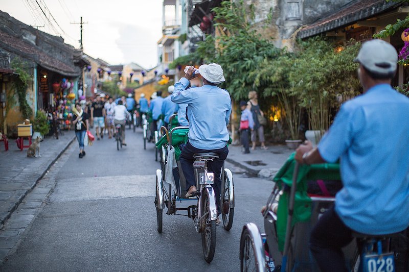 A line of rikshaw bicycles lead tourists through town.