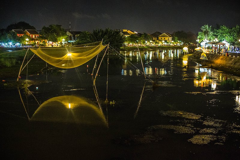 Fishing nets hang above the dry river.