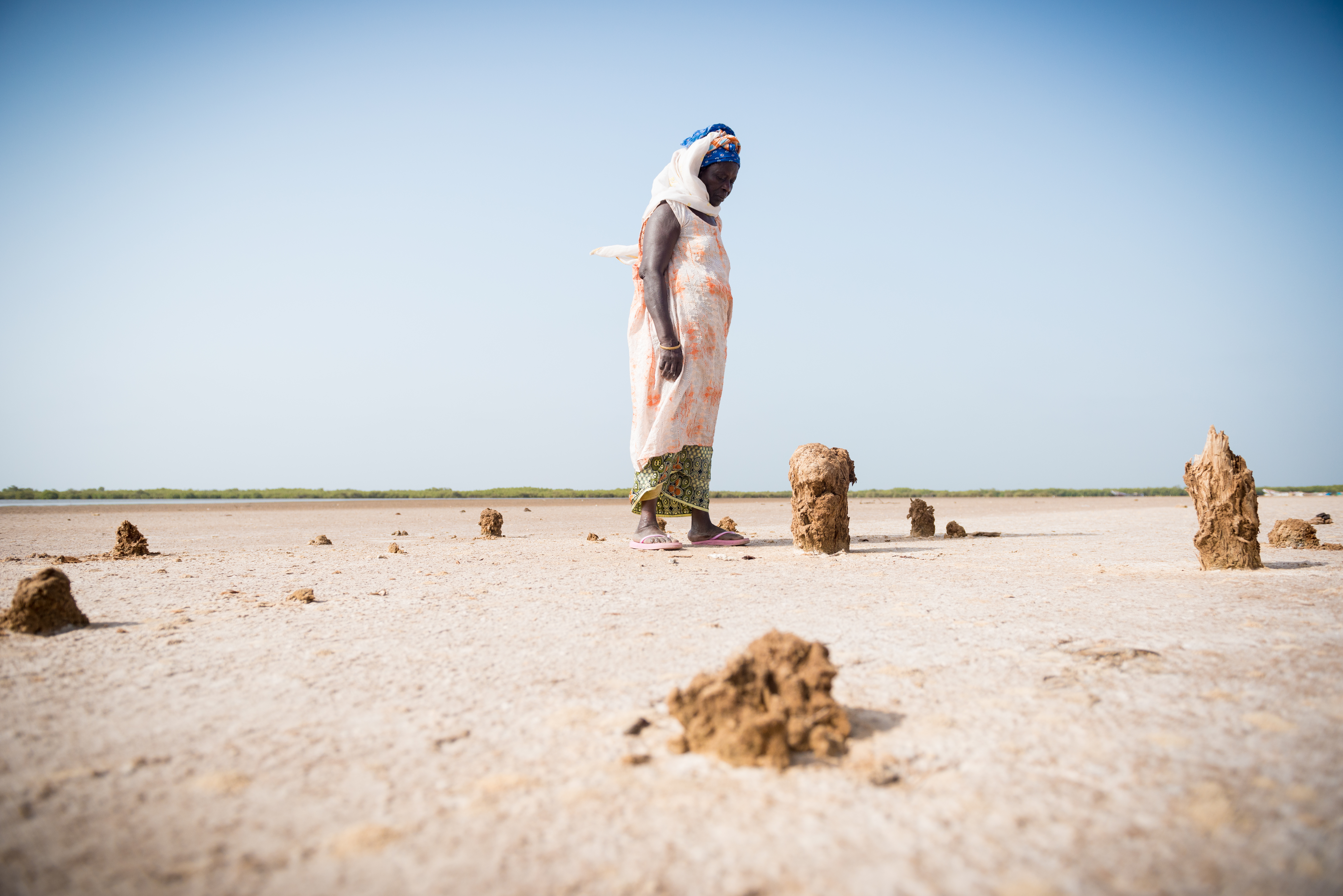 Bineta stands by the remains of the rice store. She was the last person in the community to get a rice harvest. © Clément Tardif / ActionAid