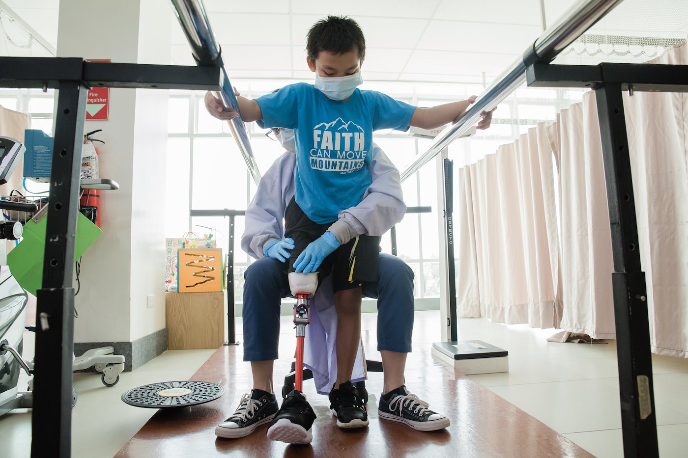 Wilson practices how to walk with his new prosthetic leg.