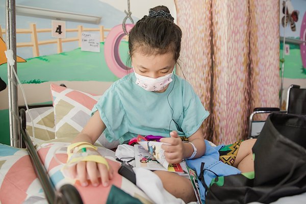 Zhaira spends time listening to Scriptures and reading Bible stories while waiting for surgery.