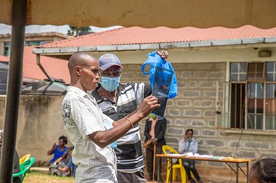 Friends trying to figure out an X-ray during mobile clinic.